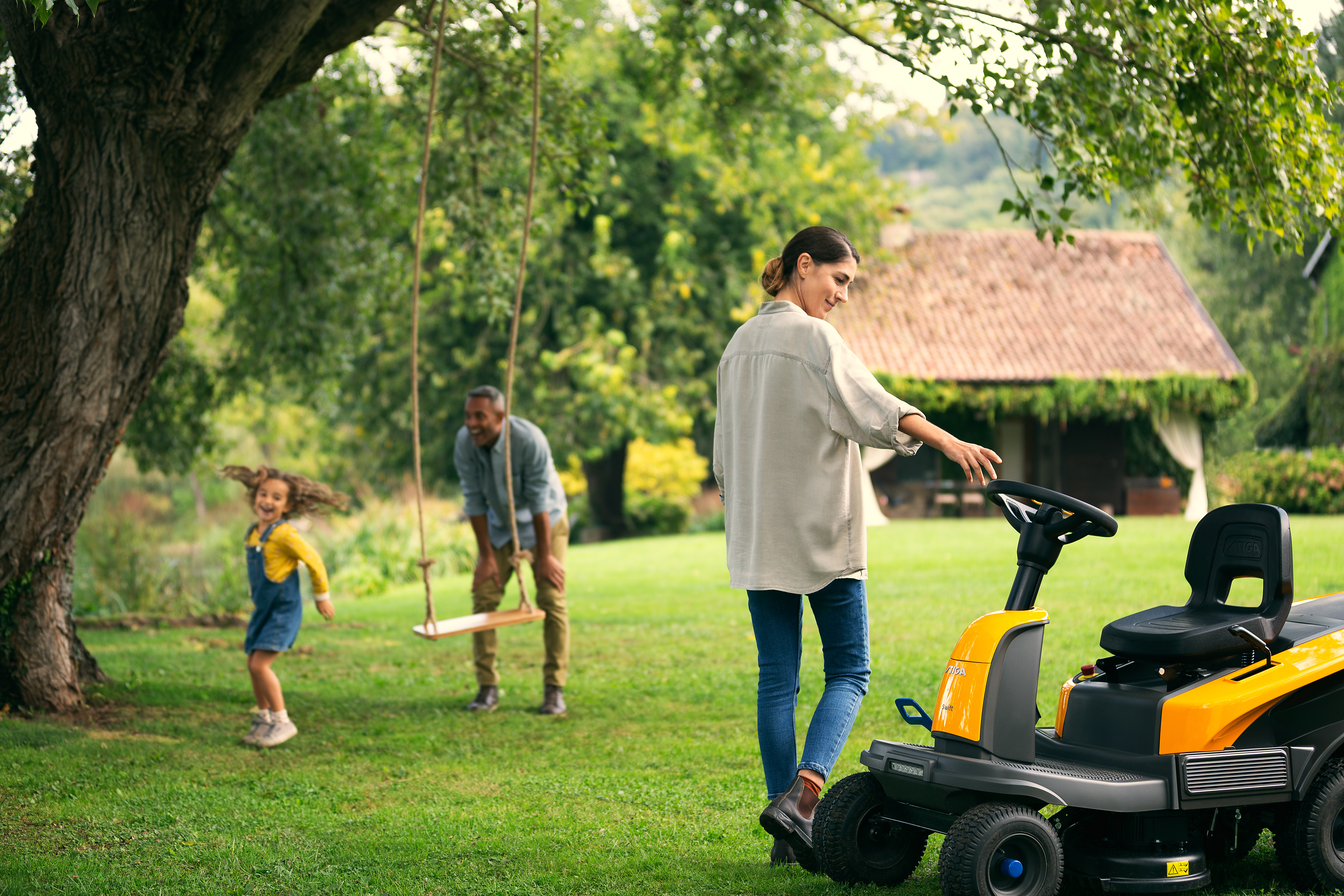 Woman and family enjoying their garden with Swift